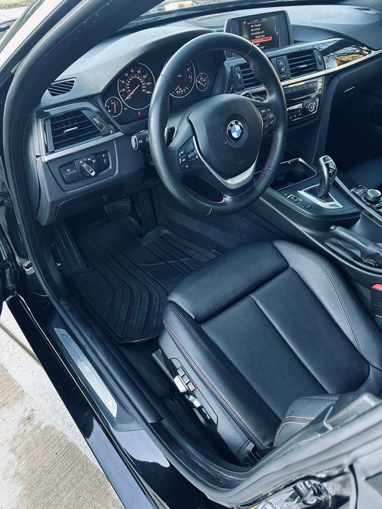 Black leather BMW 4 Series interior and floor mats after a detail