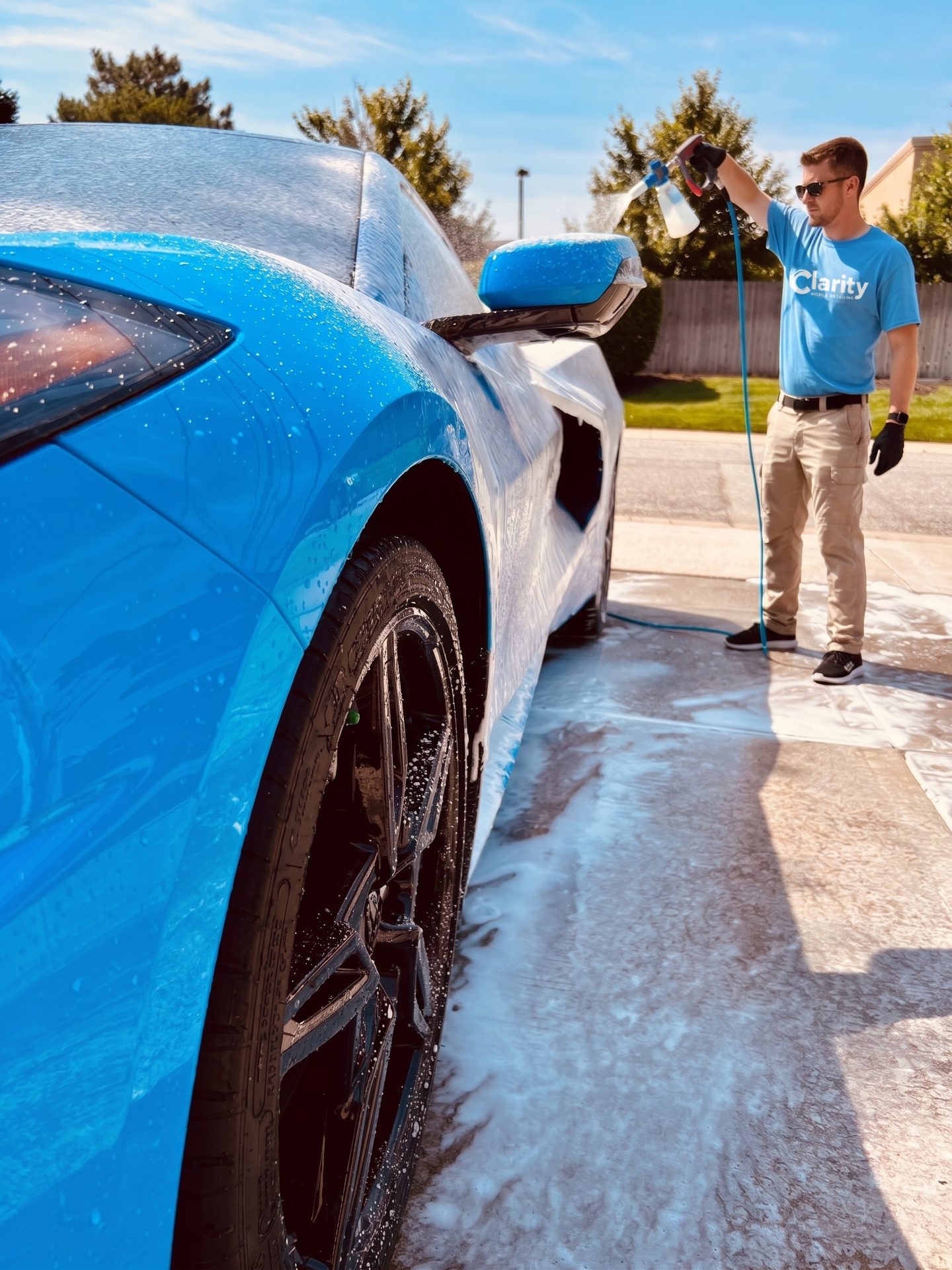 Clarity detailer foam washing a blue Corvette