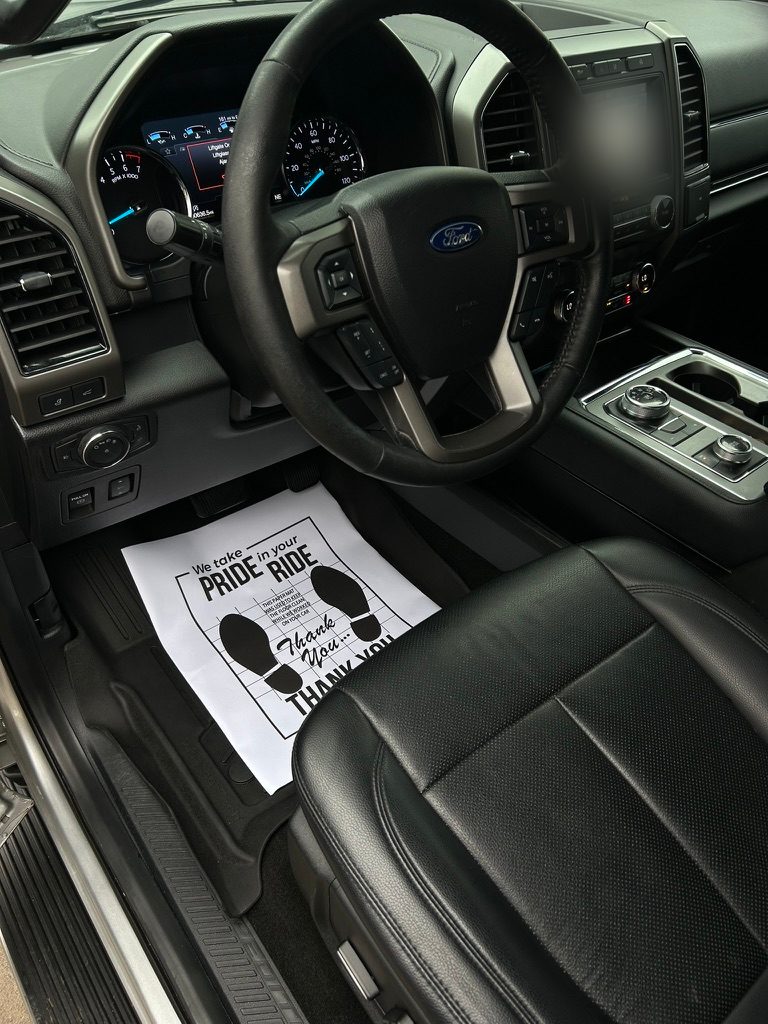 Ford Expedition front seat and dash after an interior detail, with a paper floor mat