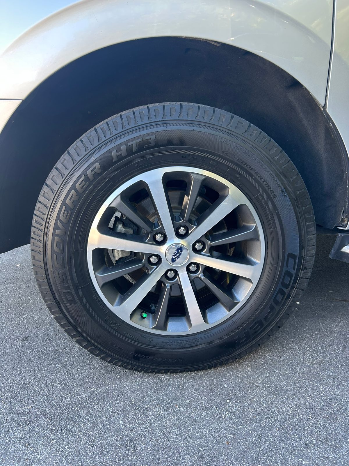 Clean Ford wheel and dressed tire after a mobile exterior detail