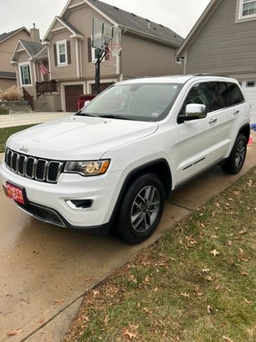 White Jeep Grand Cherokee after a detail in a driveway
