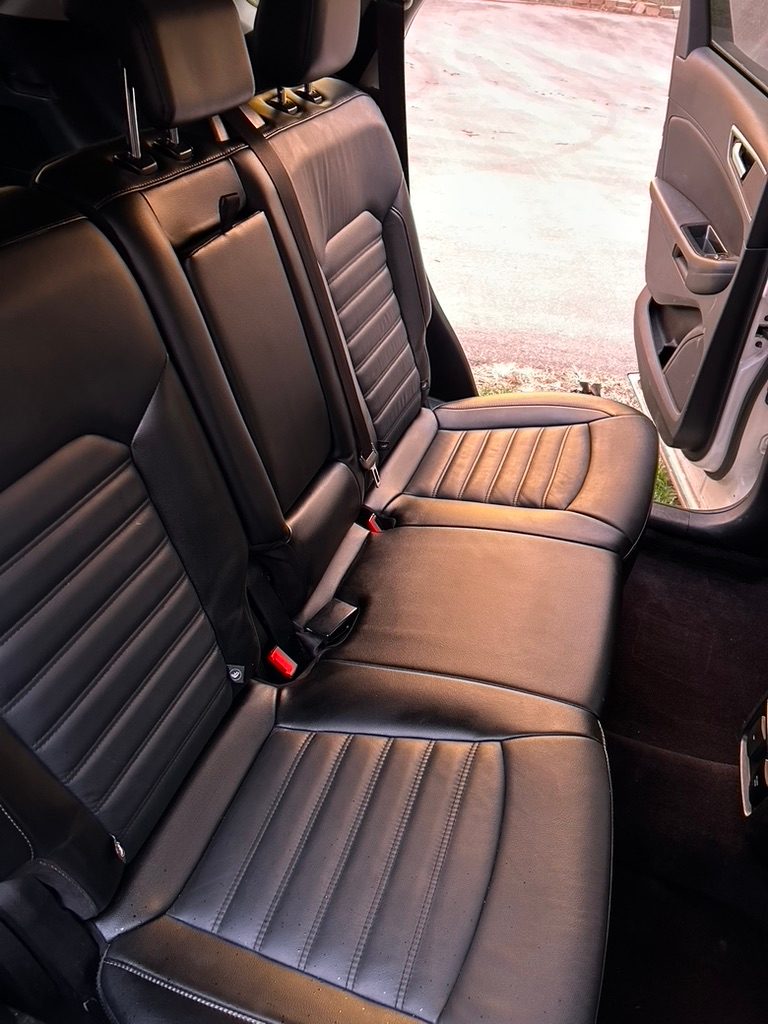 Black leather rear seats after a mobile interior detail