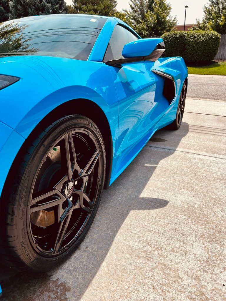 Blue Corvette with clean black wheels after a mobile exterior detail