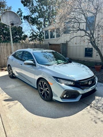 Silver Honda Civic hatchback after a detail in an Overland Park driveway