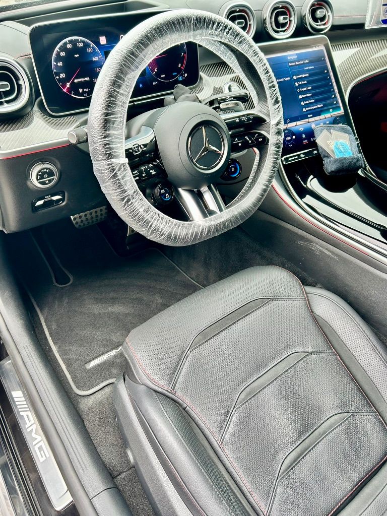 Interior of a Mercedes-AMG after a detail in Overland Park, with a protective cover on the steering wheel