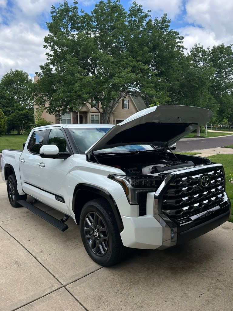 White Toyota Tundra with the hood open after a detail in an Overland Park driveway
