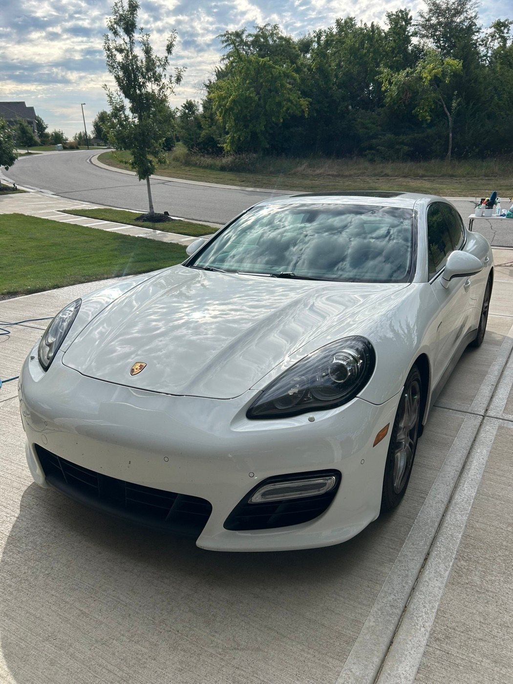 White Porsche Panamera after a detail, parked in a driveway