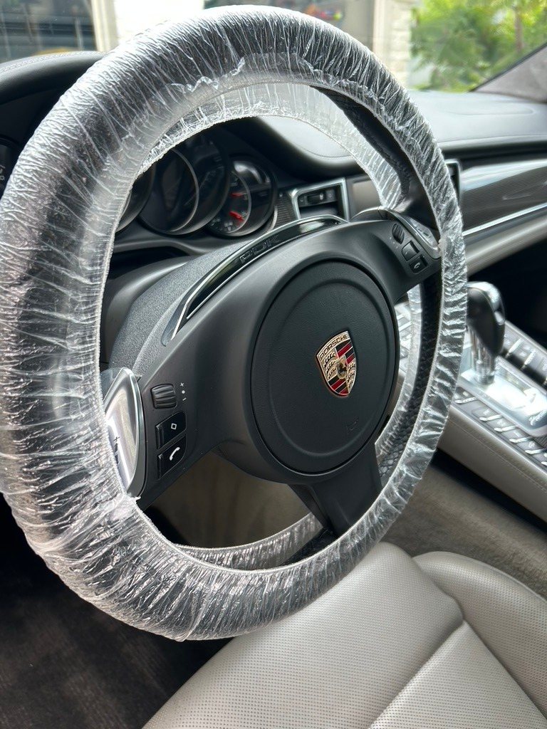 Porsche steering wheel with a protective cover after an interior detail