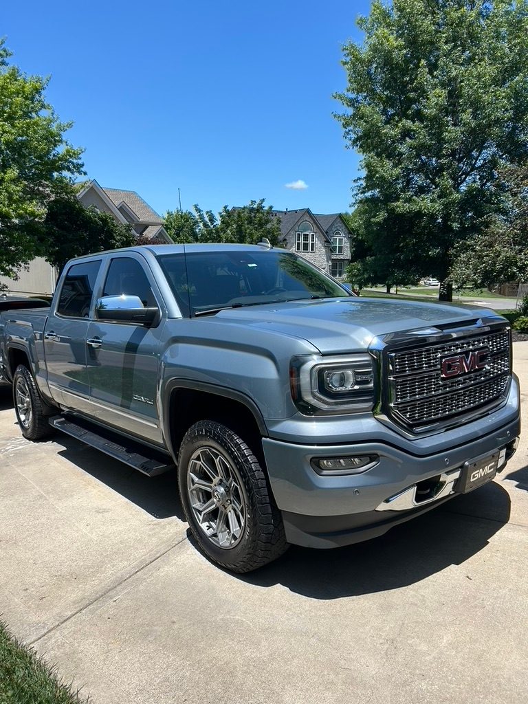 Gray GMC Sierra Denali after a detail in a Shawnee driveway