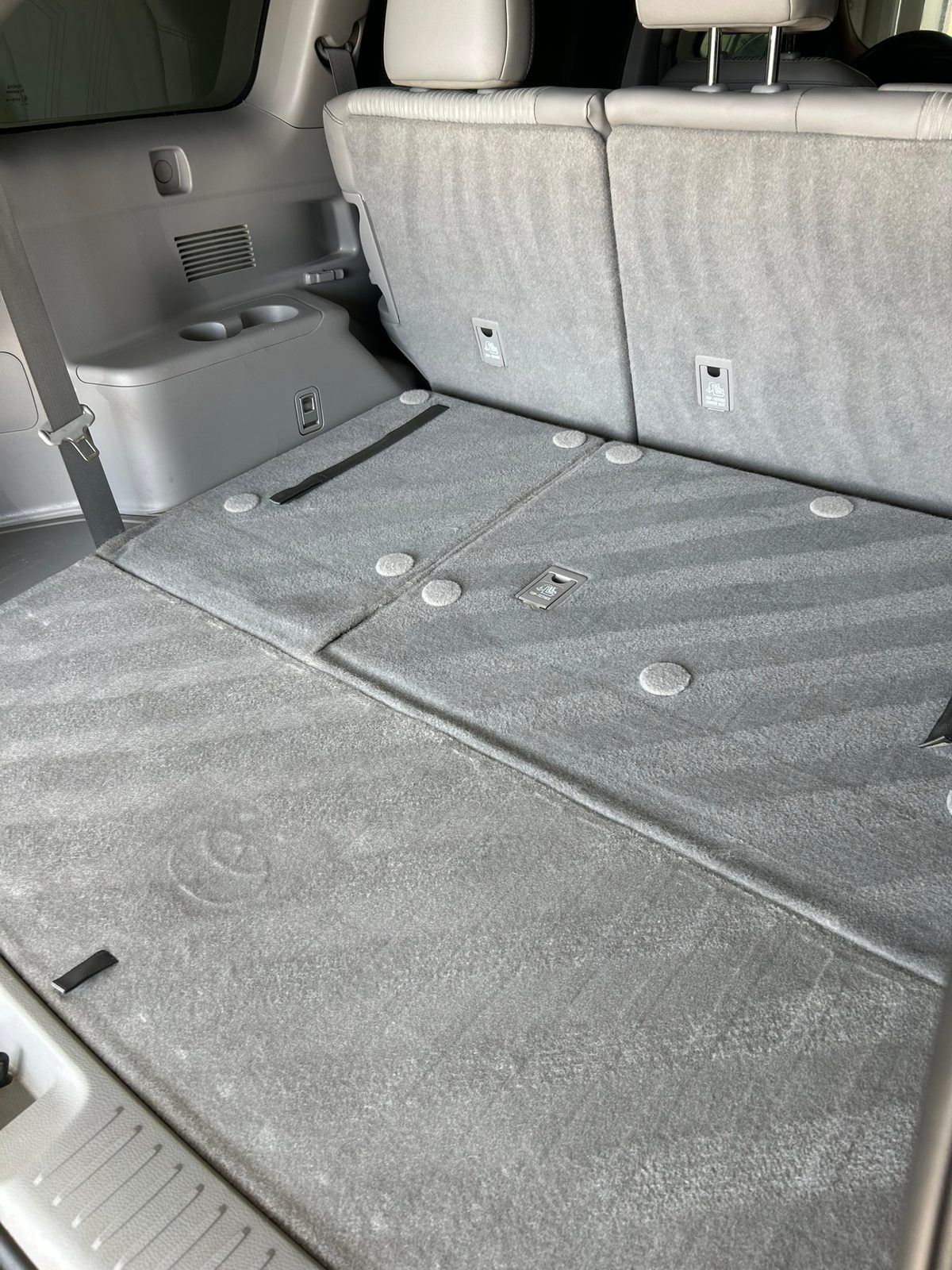 Gray carpet in a Toyota cargo area after vacuuming during an interior detail